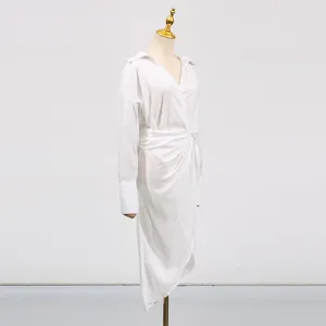 Detailed side view of white V-neck midi dress with waist drape and irregular hemline