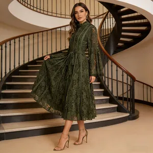 Detail view of an elegant dark green lace maxi dress with flared sleeves on stairs.