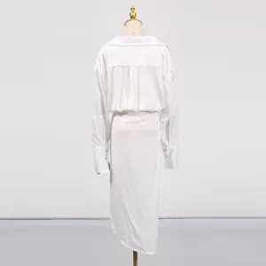Detailed back view of an elegant white V-neck midi dress featuring a stylish irregular slit design.