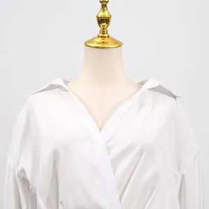 Detailed close-up of the elegant V-neck design on a stylish white solid color dress