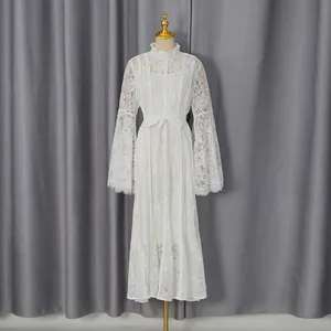Full view of elegant white lace long-sleeved dress with waist tie detail.