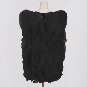 Close-up back view of a black sleeveless ruffle layered mini dress displayed on a mannequin