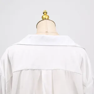 Close-up back view detail of a white V-neck casual dress showing collar and pleats
