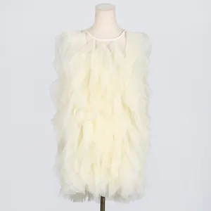 Close-up detail of exquisite multilayered ruffles on an elegant cream white summer mini dress.