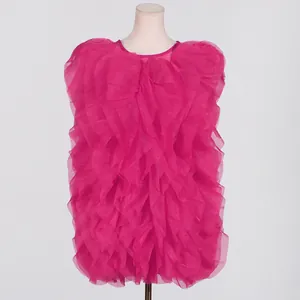Detailed view of fuchsia tiered ruffled mini dress featuring layered organza ruffles
