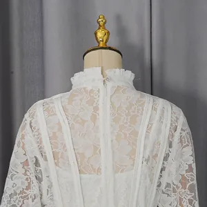Back detail view of an elegant white floral lace dress featuring a high ruffled neck
