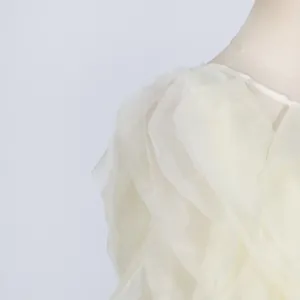 Detailed macro view of layered ruffles on a creamy off-white summer dress fabric