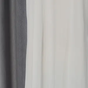 Detailed close-up view showing the grey woven and white lace fabrics of an elegant dress