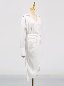 Elegant white V-neck midi dress with irregular split and wrap waist detail