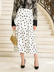 Elegant white A-line midi skirt with black polka dots and high waist design