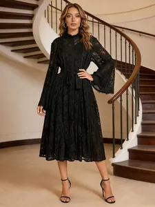 Elegant black lace midi dress with long bell sleeves and waist tie on fashion model