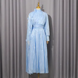 Elegant light blue pleated maxi dress featuring shimmering fabric and a high neckline.