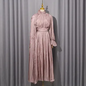 Elegant mauve pleated high-neck long dress with floral appliques on mannequin.