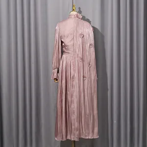 Detail view of mauve pleated maxi dress showing floral appliqués on the back.