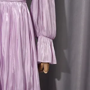 Close-up of lavender pleated dress with elegant lantern sleeves and ruffled cuffs.