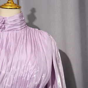 Close-up detail of pleated lavender French style evening dress with elegant floral collar.