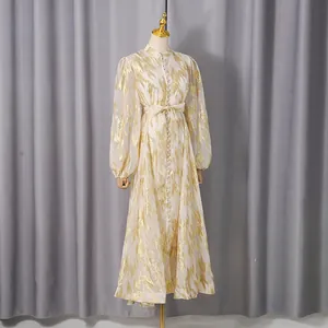Elegant long-sleeved maxi dress featuring a gold metallic abstract pattern on a mannequin