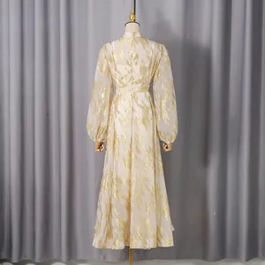 Back view of elegant long dress with gold metallic flame pattern and long sleeves
