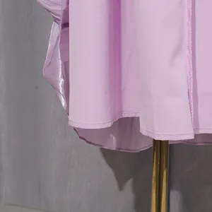 Close-up detail of lavender pleated French style dress showing fine hemline stitching