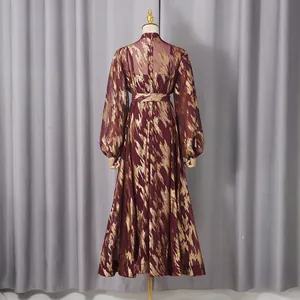 Back view of wine red elegant long dress with metallic gold abstract patterns and lantern sleeves