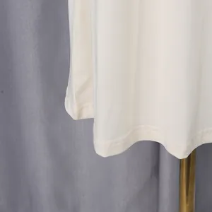 Detailed macro shot of fine double-needle stitching on white elegant summer dress hem.
