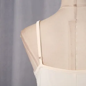 Detailed macro view of thin adjustable shoulder strap and neckline of an elegant dress