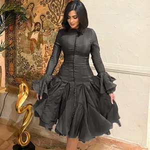 Elegant charcoal grey long-sleeved dress with ruffled cuffs and pleated skirt details