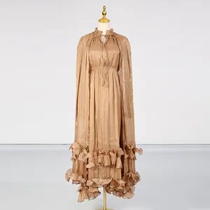 Detailed view of elegant light brown pleated maxi dress with tiered ruffled hem and tie-neck