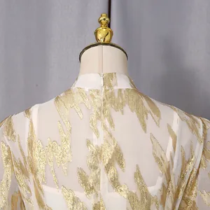 Back detail of elegant white dress with shimmering gold leaf pattern and hidden zipper