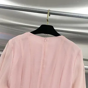Close-up of the invisible back zipper on a elegant pink mesh mermaid dress fabric texture