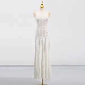 Detail of French sleeveless white lace maxi dress with elegant hollow out wave patterns