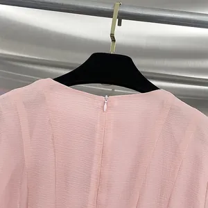 Close-up view of the elegant pink dress showing high-quality hidden back zipper detail
