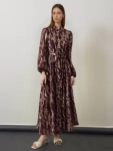 Elegant long-sleeved metallic pattern maxi dress featuring a belted waist and collar