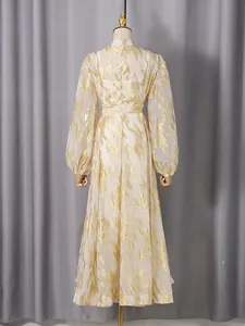 Elegant long sleeve white maxi dress featuring a shimmering gold metallic feather pattern design