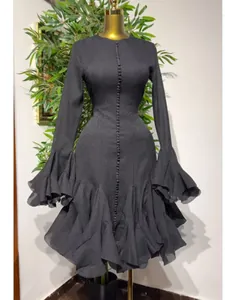 Elegant black long sleeve mermaid dress with ruffled sleeves and tiered hem design