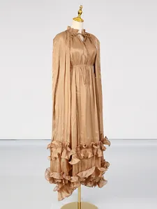 Elegant champagne maxi dress with ruffled hem and cape design