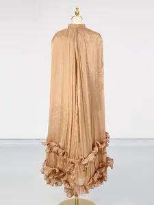 Elegant brown pleated maxi dress with ruffled hem and textured fabric on a mannequin