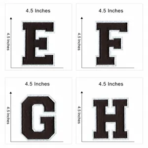 Macro detail of 4.5 inch brown embroidered iron-on varsity letter patches E F G H