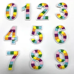 Detailed view of rainbow striped embroidered number patches from zero to nine.