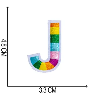 Macro view of rainbow embroidered letter J patch showing 4.8cm x 3.3cm dimensions