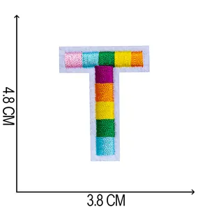 Detailed view of colorful rainbow embroidered letter T patch with size dimensions 4.8x3.8 cm