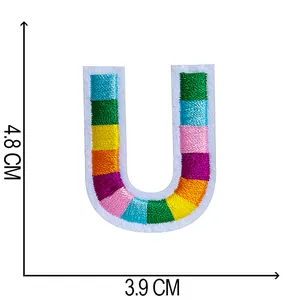 Macro detail of multicolored embroidered letter U patch with 4.8x3.9cm dimensions
