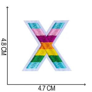 Detailed close-up showing the precise measurements of the colorful embroidered letter X patch