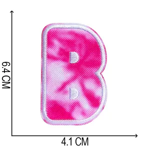 Detailed view of tie-dye embroidered letter B patch with size dimensions 6.4x4.1 cm.
