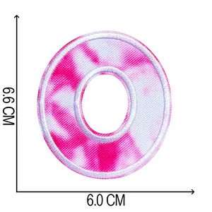 Detailed view of tie-dye embroidered letter O patch with dimensions 6.6x6.0cm