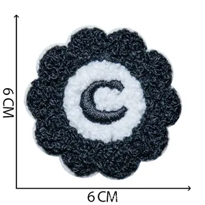 Detailed view of a 6cm chenille embroidered flower patch with letter C for DIY