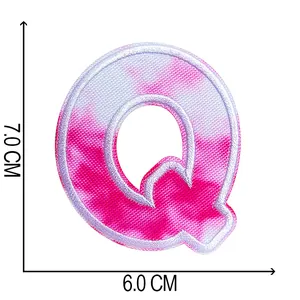 Detail view of 7x6cm pink tie-dye embroidered letter Q patch for DIY clothing decor