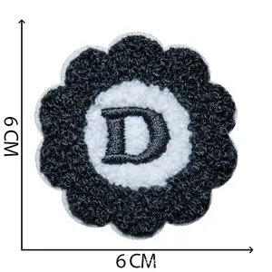 A close-up detail of a 6x6cm chenille embroidery flower patch featuring a black letter D