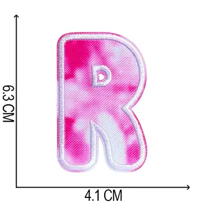 Detail view of tie-dye embroidered letter R patch showing 6.3cm height and 4.1cm width