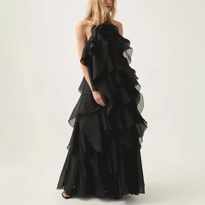 Full length shot of an elegant black halter neck maxi dress with cascading tiered ruffles